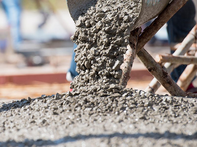 Gietende natte betonstroom vanuit een glijgoot